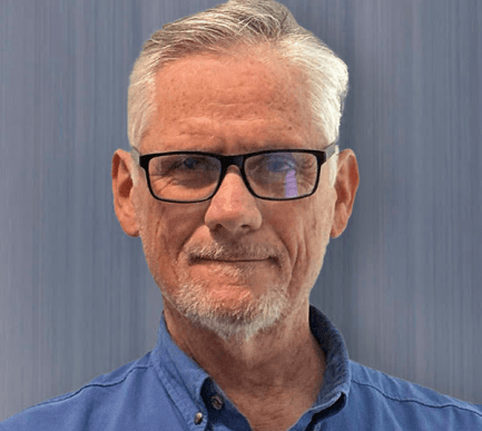 Keith Petrus wearing dark glasses and a blue shirt